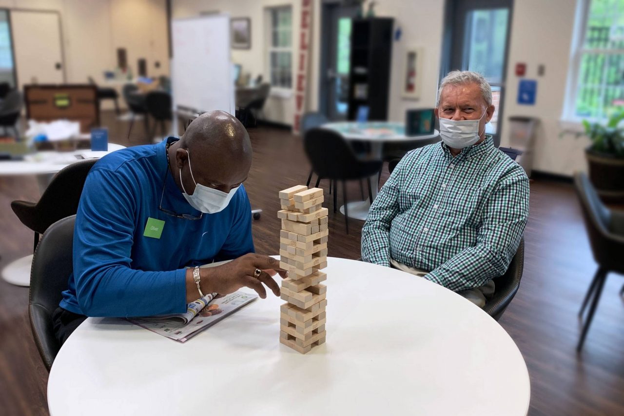 Members of renew Montessori center for aging and memory play a game of Jenga